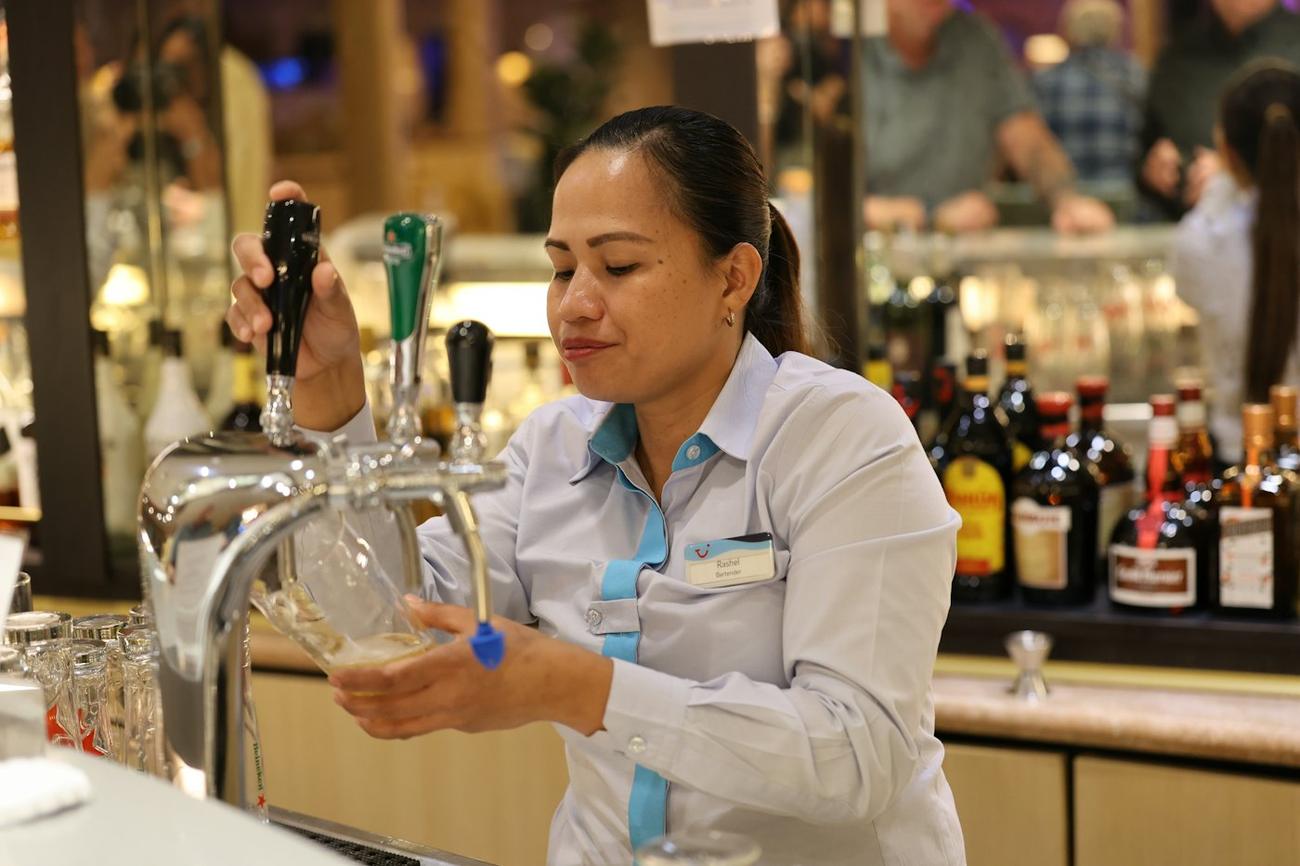 A bartender pouring a pint