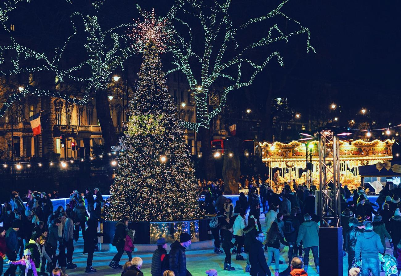 Crowds at a town centre Christmas market at night