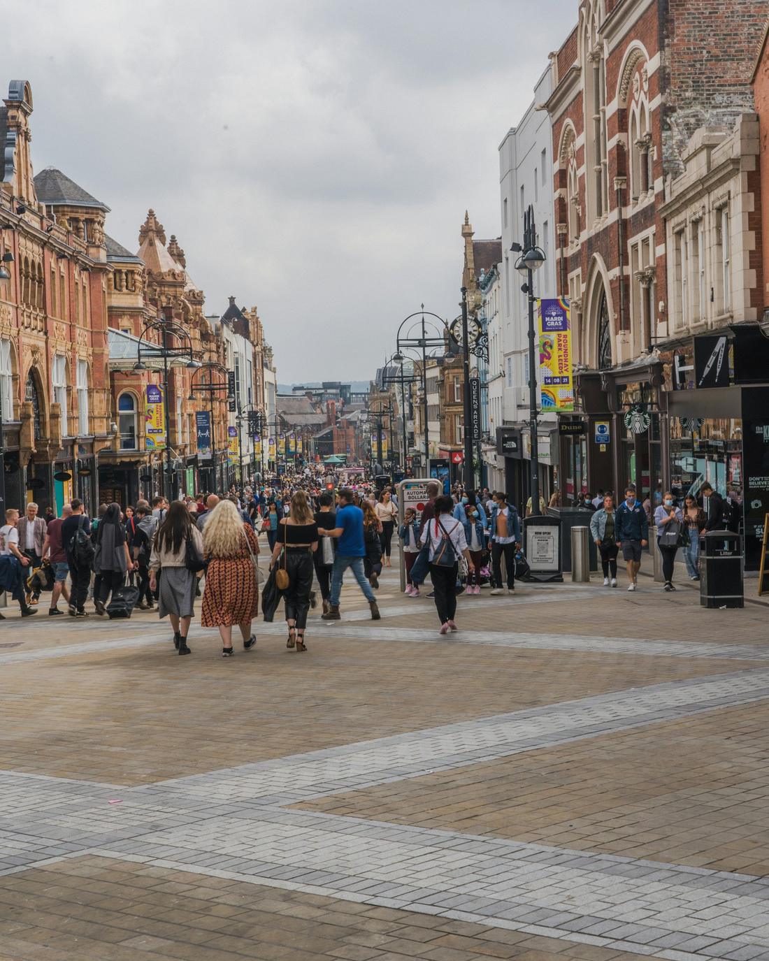 A busy British high street on a bright day