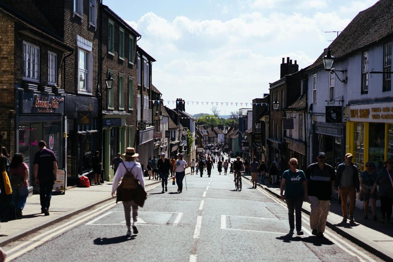 People walking down a market town street