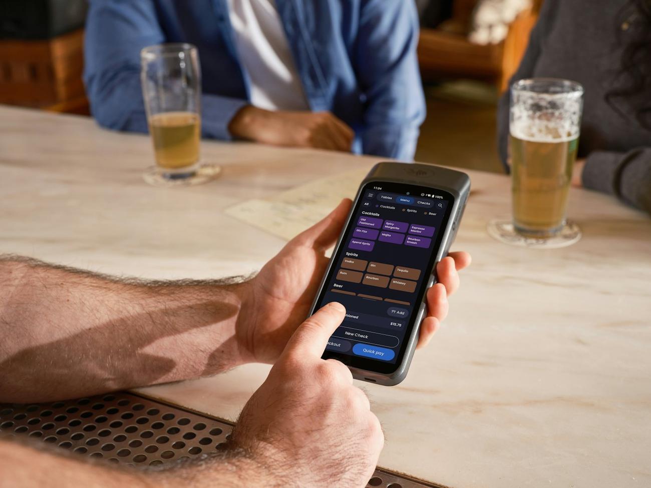 Someone using a phone at a bar